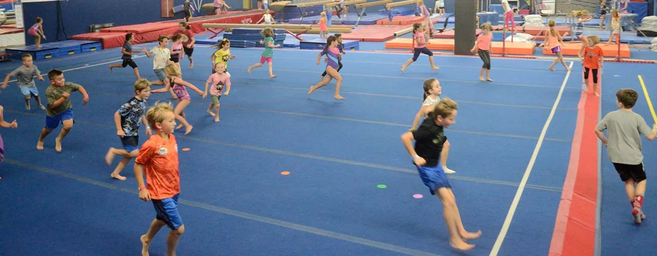 Kids running across the PEGA gym floor